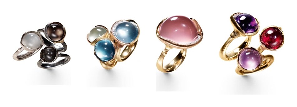 Four Ole Lynggaard rings set with cabochon stones in silver and gold