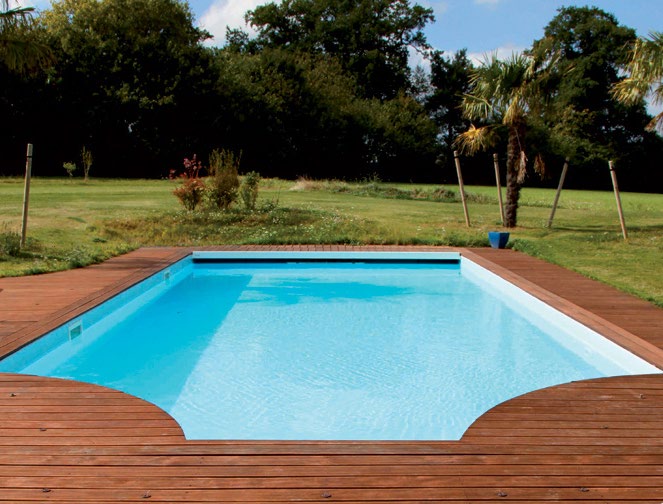 An outdoor swimming pool with a blue liner, set into a wooden deck in a garden